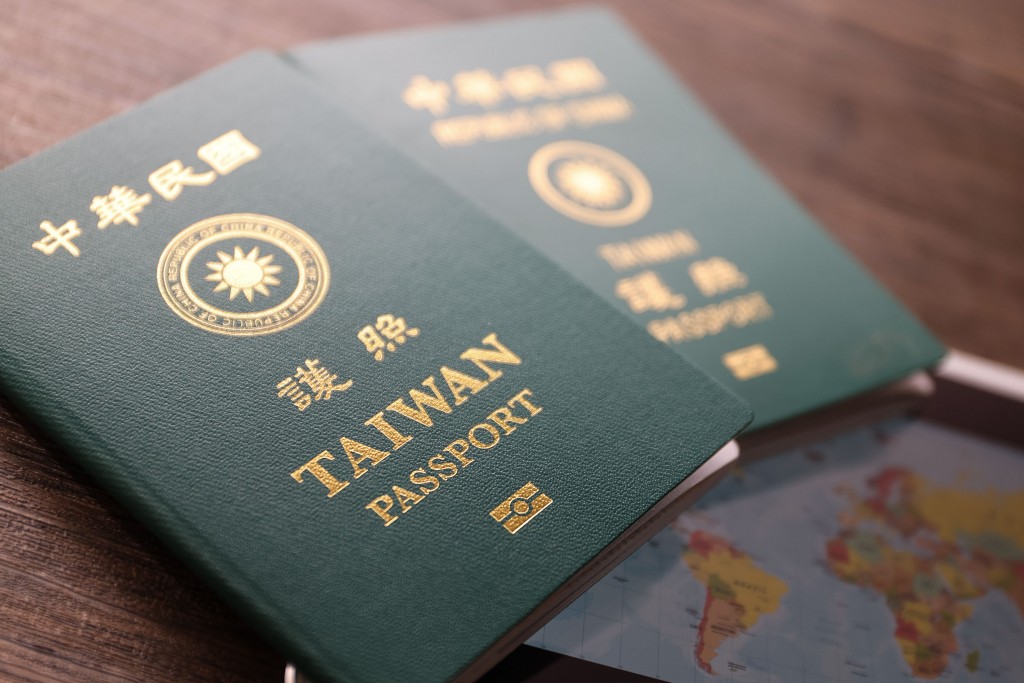 New Taiwan passport (foreground) placed over old passport. 
