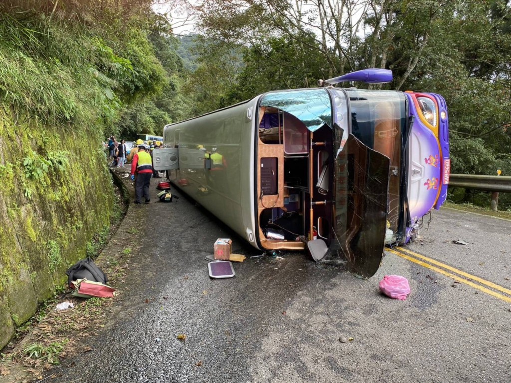Bus flips over after brake failure.
