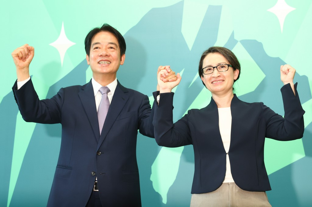 Lai Ching-te (left) and Hsiao Bi-khim hold arms up as she is announced as his running mate on Nov. 20. 
