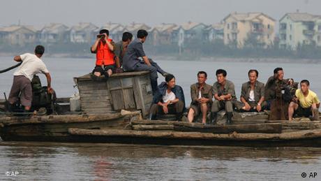 North Koreans seen floating on the Yalu river, which borders China's northeast Liaoning province
