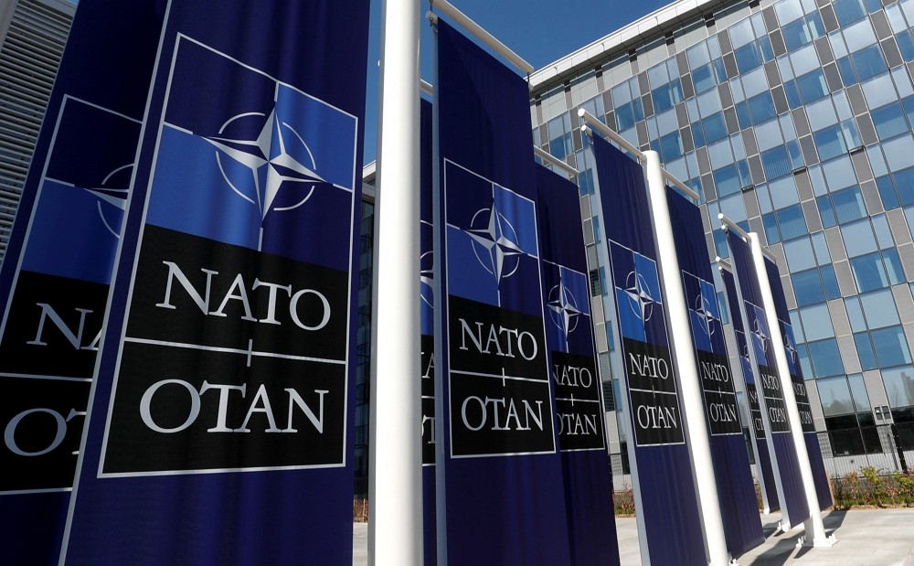 Banners displaying the NATO logo are placed at the entrance of new NATO headquarters during the move to the new building, in Bruss...