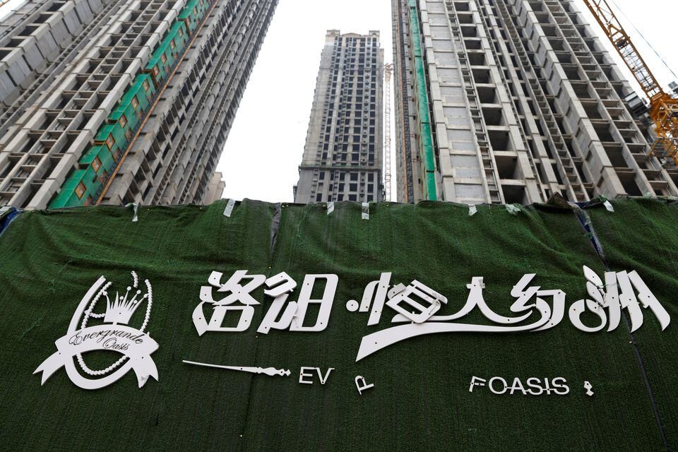 Peeling logo of Evergrande Oasis pictured outside unfinished construction site in Luoyang, China Sept. 16, 2021. (Reuters photo)
