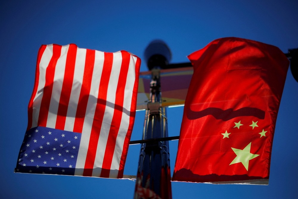 The flags of the United States and China fly from a lamppost in the Chinatown neighborhood of Boston, Massachusetts, U.S., Novembe...