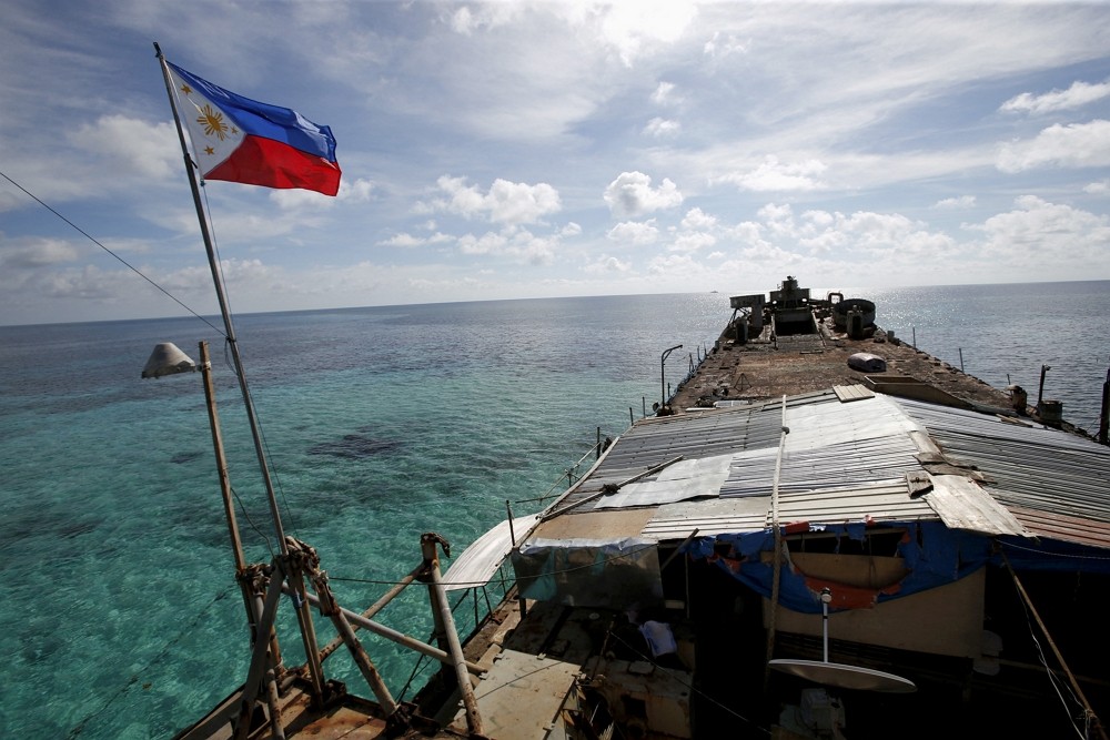 A Philippine flag flutters from BRP Sierra Madre, a dilapidated Philippine Navy ship that has been aground since 1999 and became a Philippine military...