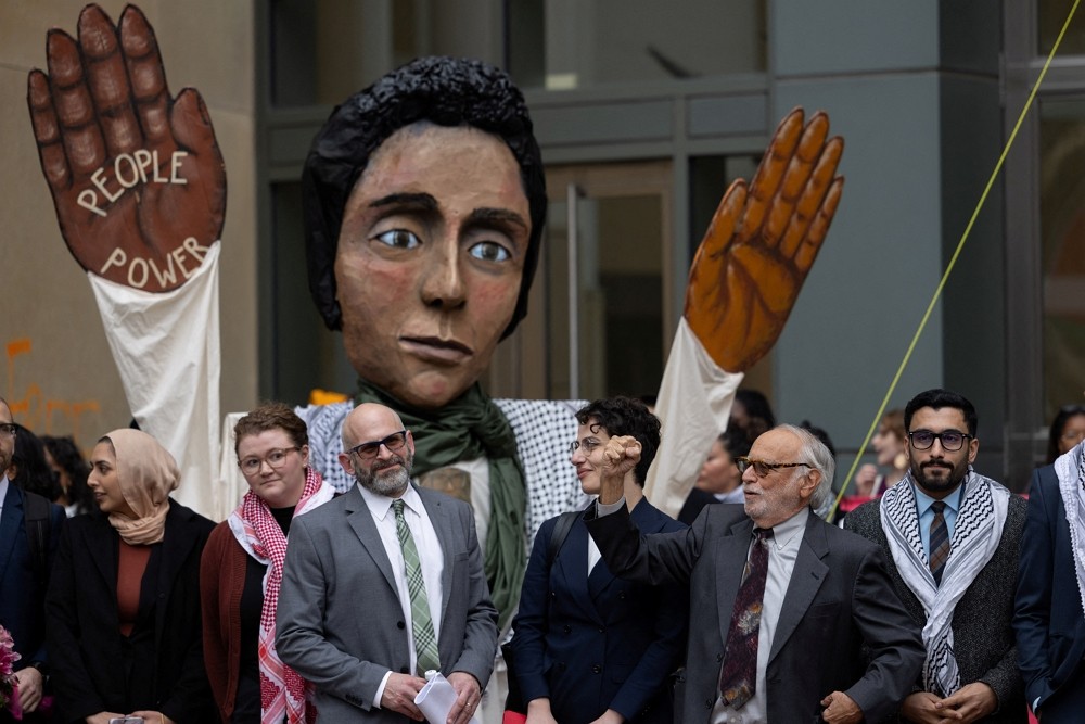 Members of the Palestinian community and lawyers stand outside of a federal court building after presenting oral argument in a lawsuit filed...