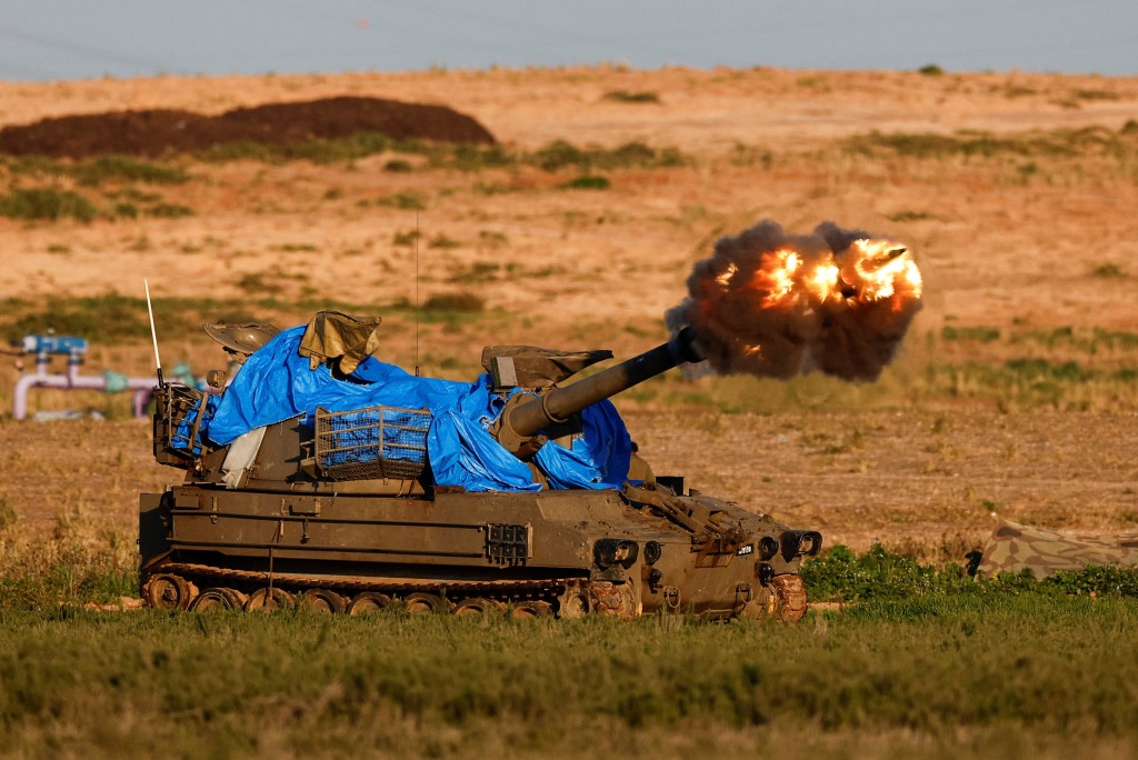An Israeli mobile artillery unit fires towards Gaza, amid the ongoing conflict between Israel and the Palestinian Islamist group Hamas, near the ...