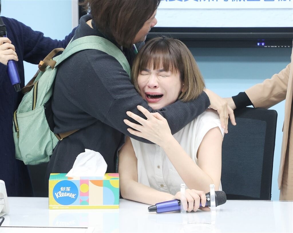Chen Yee (center) comforted by her mother as she cries at a press conference on Feb. 6. 
