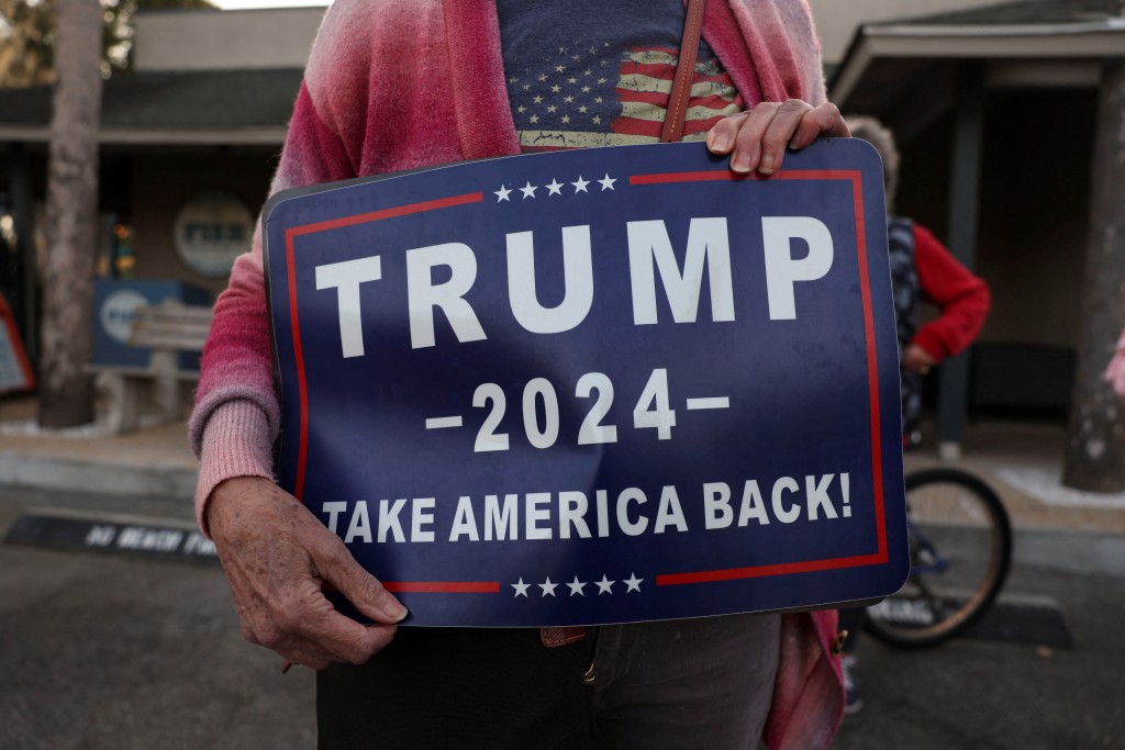 A Donald Trump supporter is pictured holding a placard on Feb. 1. (REUTERS, Shannon Stapleton photo)
