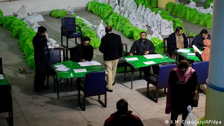 Pakistan election staff prepare a polling station in Lahore