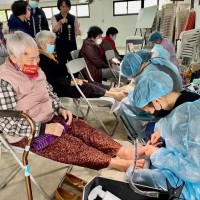 Volunteers clip toenails for 600 of Taiwan's elderly